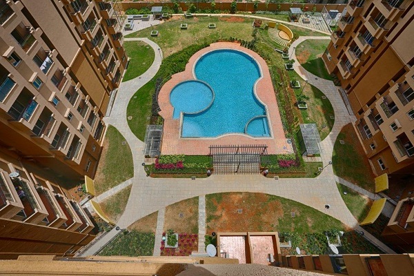 The towers in Salarpuria Gold Summit are arranged around a swimming pool
